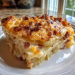 A hearty, cheesy slice of scalloped potatoes and ham with a deeply browned, bubbly top crust.