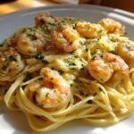 A close-up of rich Creamy Lemon Garlic Shrimp Pasta featuring plump shrimp tossed in a bright, creamy sauce and garnished with parsley.