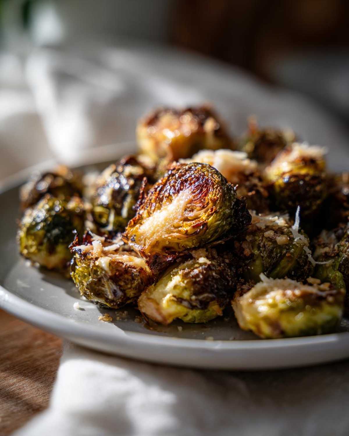 Close-up of roasted Crispy Parmesan Brussels Sprouts, showing caramelized edges and grated cheese.