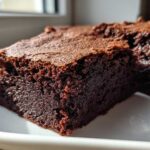 Close-up of a rich, fudgy square of Dark Chocolate Tahini Brownies with a crackly top.
