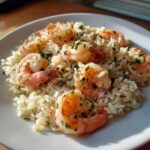 Close-up of Garlic Butter Shrimp and Rice Skillet, featuring plump shrimp over white rice, garnished with parsley.
