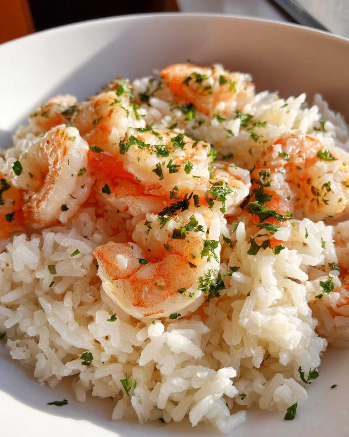 Close-up of Garlic Butter Shrimp and Rice Skillet, featuring plump shrimp over white rice topped with fresh parsley.