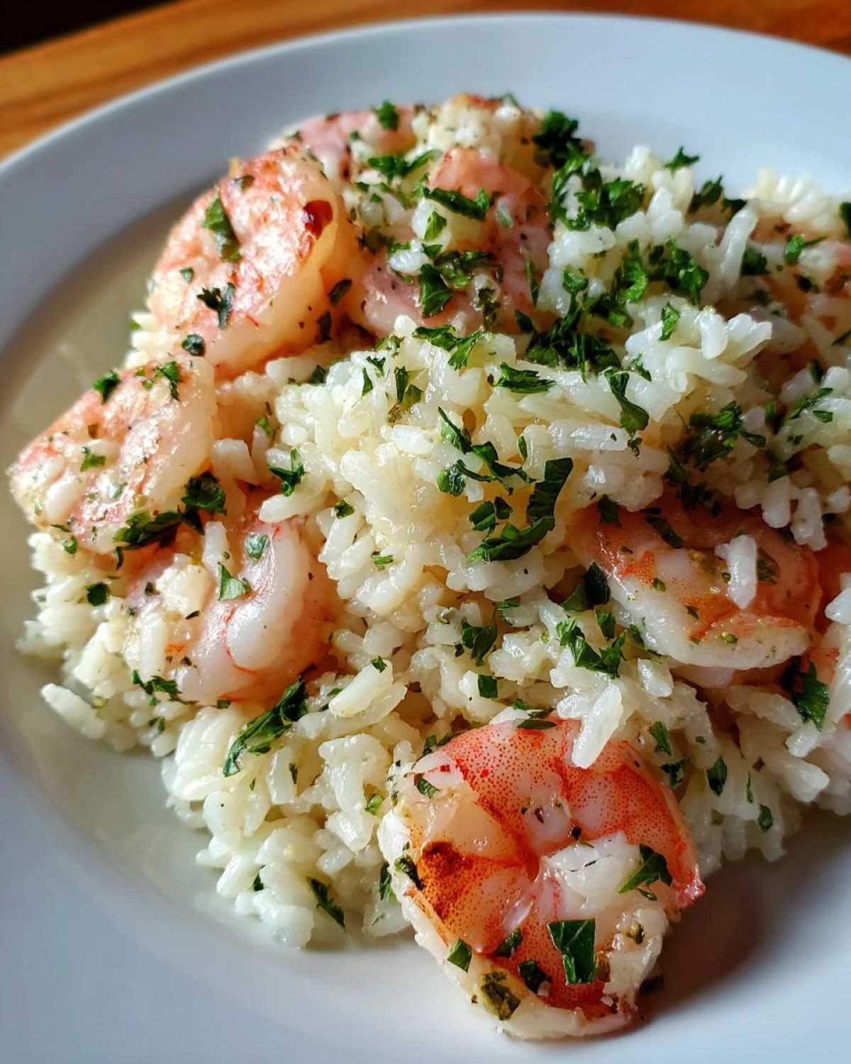 Close-up of Garlic Butter Shrimp and Rice Skillet topped with fresh parsley.