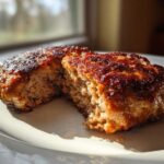 Close-up of a perfectly cooked Air Fryer Turkey Burger, cut open to show its juicy interior and caramelized crust.
