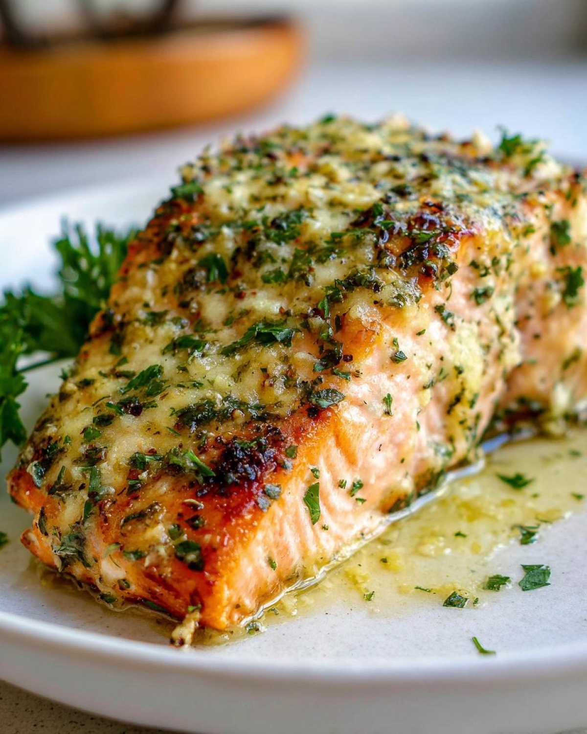 Close-up of a perfectly cooked Keto Garlic Butter Salmon fillet topped with herbs and butter sauce.
