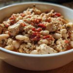 Close-up of Spicy Turkey White Bean Chili featuring ground turkey, white beans, and diced tomatoes in a white bowl.