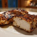 Close-up of sliced, perfectly cooked chicken breast showing juicy white meat and charred exterior from a great chicken marinade.