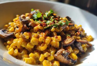 Close-up of creamy Mexican Street Corn Salad MushroomSalus topped with mushrooms, chili flakes, and cilantro.