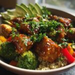 Close-up of Perfect Honey Mustard Chicken Bowls featuring glazed chicken, broccoli, peppers, and sliced avocado over quinoa.
