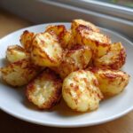 A white plate piled high with golden brown, crispy Simple Irish Roasted Potatoes.