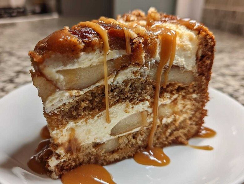 A decadent slice of Caramel Apple Cheesecake Cake layered with cake, cream cheese filling, and apples, topped with caramel sauce.