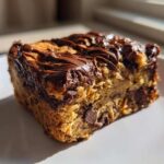 A single square serving of Delicious Brookie Baked Oats Recipe topped with melted chocolate.