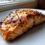 Close-up of a perfectly grilled salmon fillet coated in a shiny, caramelized Salmon Marinade for Grilled Dinner.