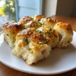 Close-up of glistening Hawaiian Roll Garlic Bread topped with melted butter, garlic, and parsley.