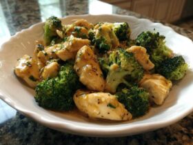 Close-up of tender chicken pieces and bright green broccoli florets coated in a glossy Garlic Butter Chicken and Broccoli sauce.