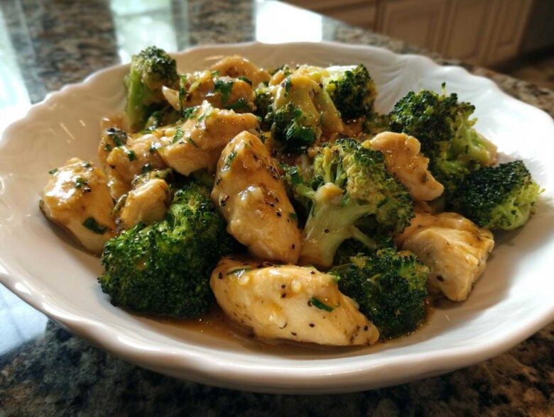 Close-up of tender chicken pieces and bright green broccoli florets coated in a glossy Garlic Butter Chicken and Broccoli sauce.