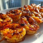 Close-up of perfectly grilled Honey Garlic Grilled Shrimp skewers with a glossy, caramelized glaze and sesame seeds.