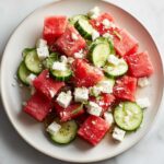 Close-up of vibrant Mediterranean Watermelon Salad with Feta, featuring cubed watermelon, sliced cucumbers, and crumbled feta cheese.